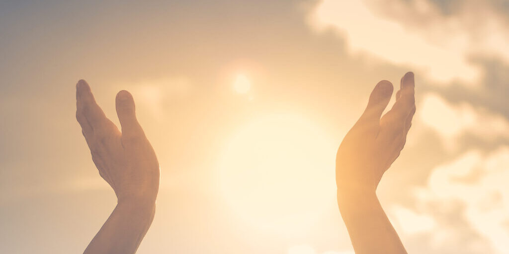 hands reaching towards the sun